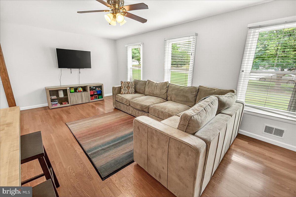 19808 Westerly Avenue Poolesville, MD 20837 - Photo 24 of 64 a living room with furniture and a flat screen tv