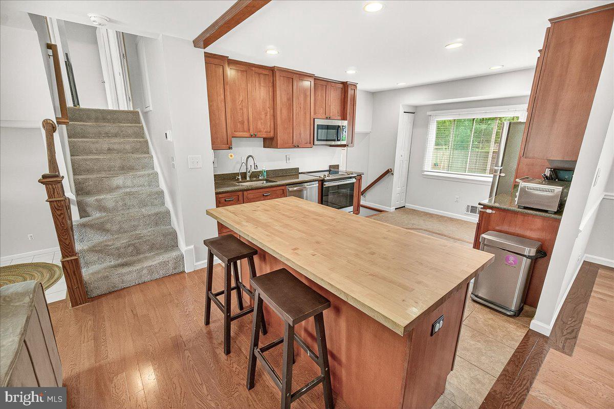 19808 Westerly Avenue Poolesville, MD 20837 - Photo 25 of 64 a open kitchen with a table chairs and wooden floor