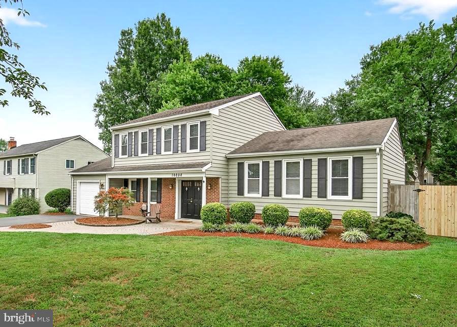 19808 Westerly Avenue Poolesville, MD 20837 - Photo 3 of 64 a front view of a house with a yard table and chairs