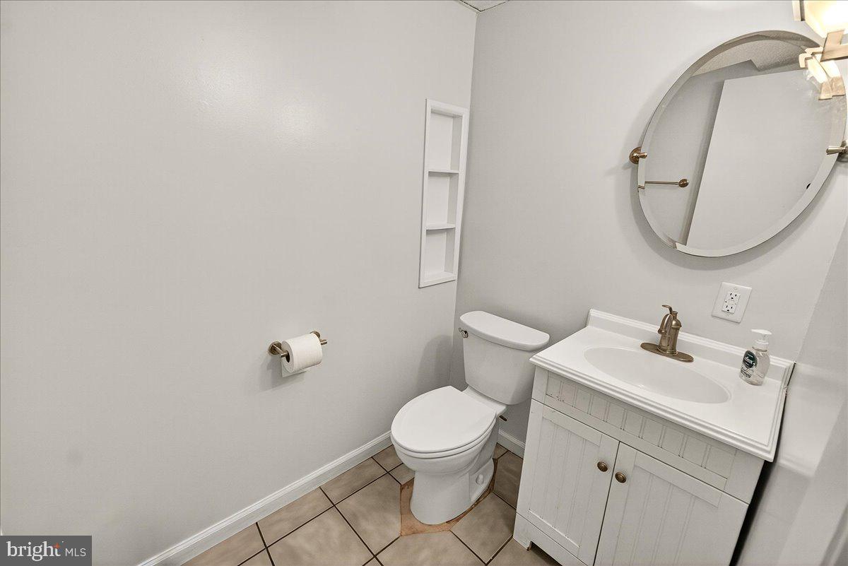 19808 Westerly Avenue Poolesville, MD 20837 - Photo 35 of 64 a bathroom with a sink a toilet and a mirror