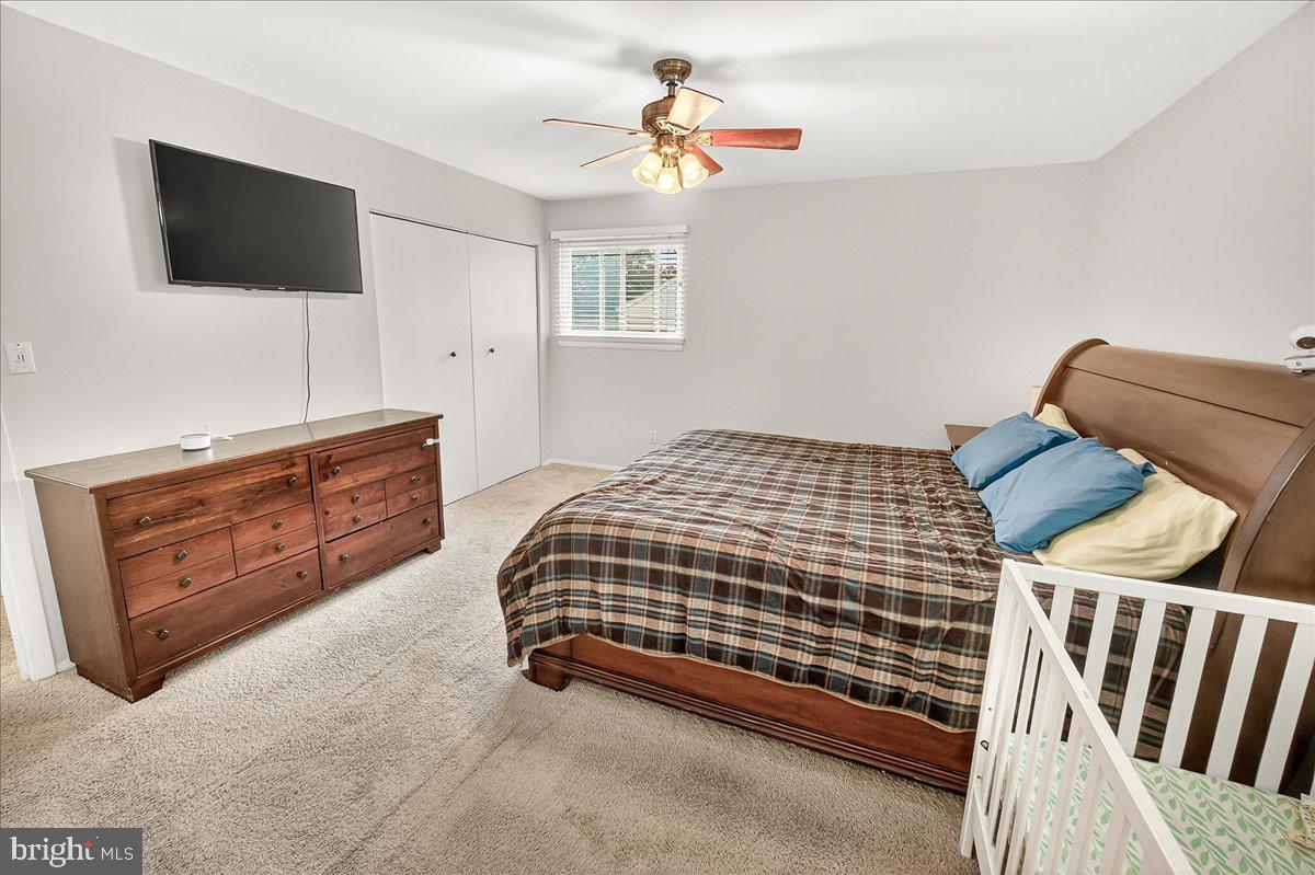 19808 Westerly Avenue Poolesville, MD 20837 - Photo 38 of 64 a bedroom with a bed and a flat screen tv