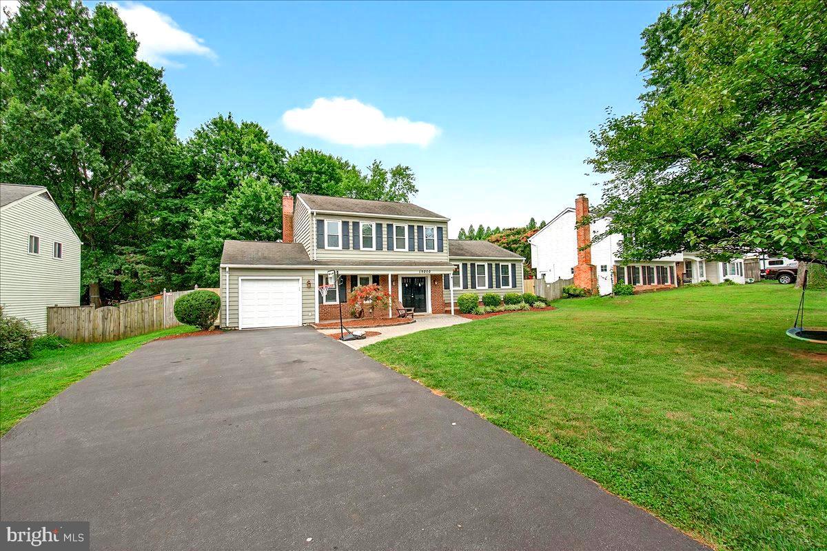 19808 Westerly Avenue Poolesville, MD 20837 - Photo 7 of 64 a front view of a house with garden