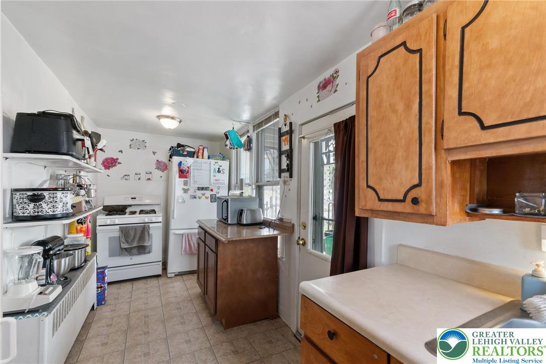 27 West Allen Street Allentown, PA 18102 - Photo 6 of 21 a kitchen that has a lot of cabinets a sink and a refrigerator