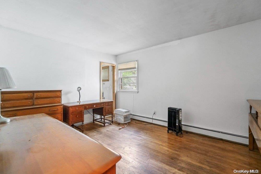 1931 Miller Place Merrick, NY 11566 - Photo 12 of 14 a room with a desk and chair with wooden floor