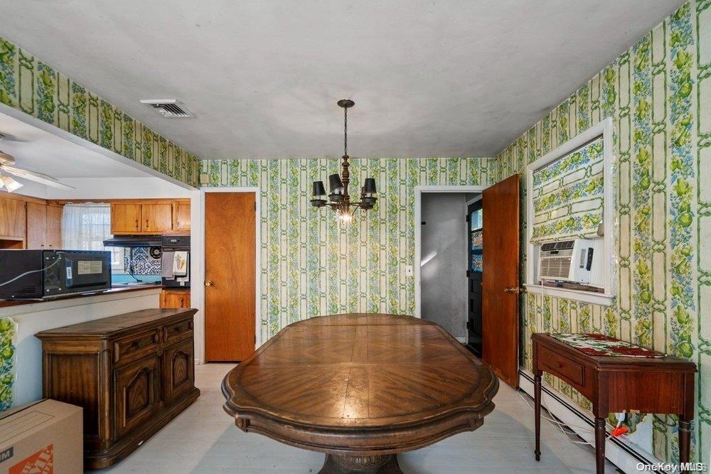1931 Miller Place Merrick, NY 11566 - Photo 5 of 14 a view of a kitchen with furniture and a chandelier