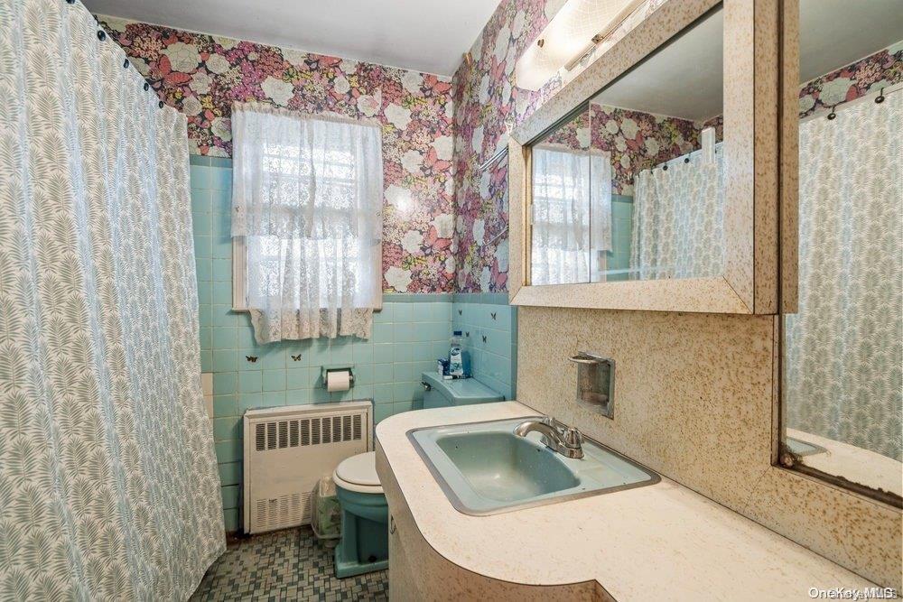 1931 Miller Place Merrick, NY 11566 - Photo 10 of 14 a bathroom with a sink toilet and shower