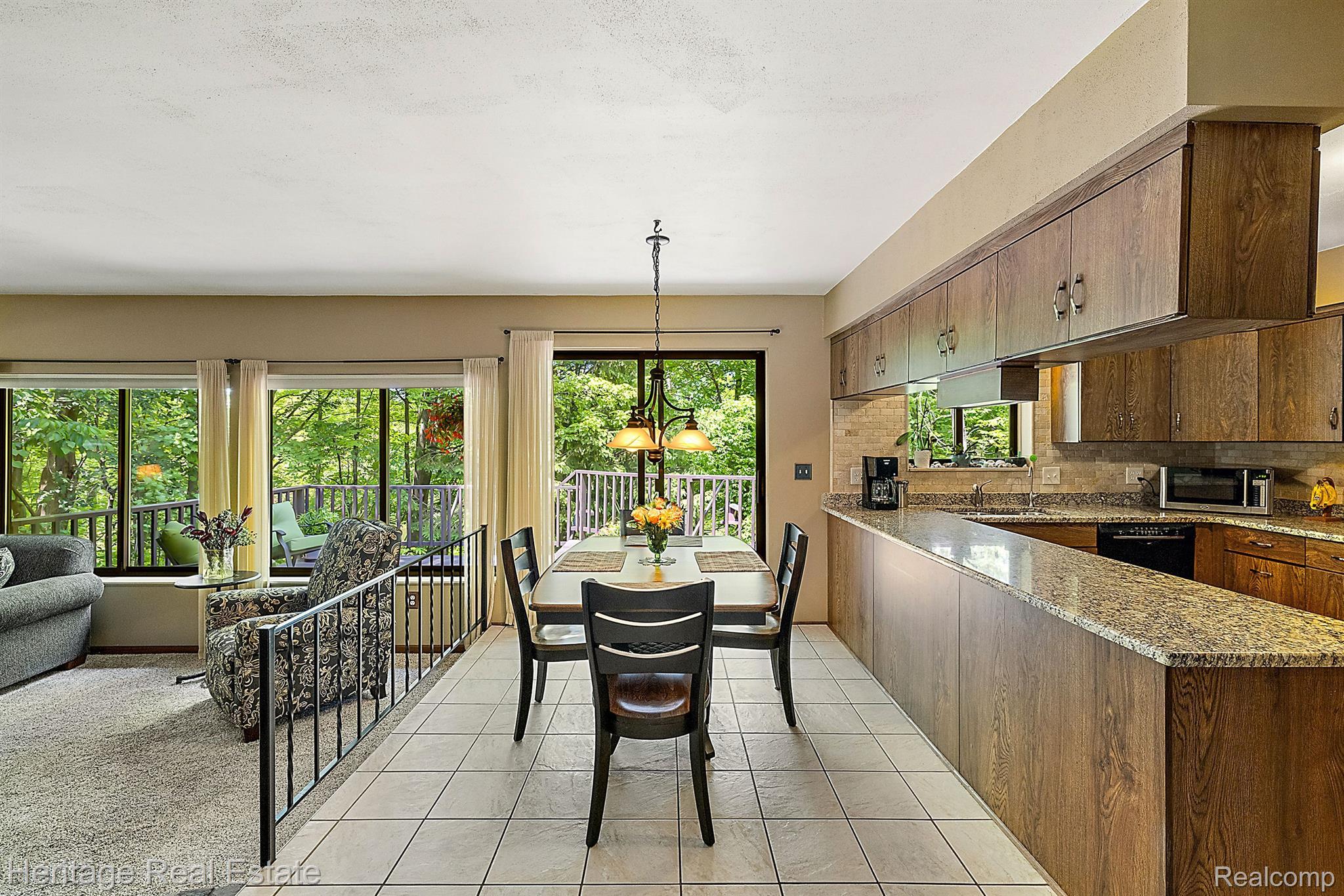 3190 West Brocker Road Metamora, MI 48455 - Photo 21 of 75 Dining & living w/ walls of windows & nature views