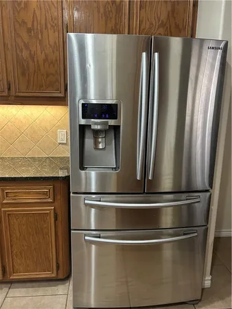 a kitchen with stainless steel appliances granite countertop a refrigerator and a stove