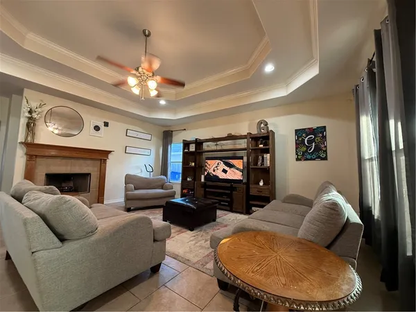 a living room with furniture a fireplace and a flat screen tv