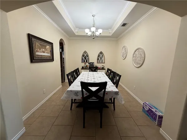 a dining room with a table and chairs