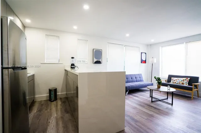 a kitchen with stainless steel appliances a refrigerator sink and cabinets