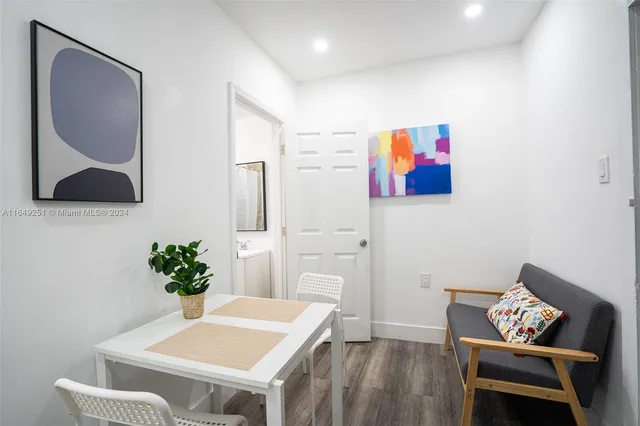 a kitchen with a sink cabinets stainless steel appliances and a window
