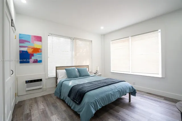 a bedroom with a bed and a potted plant