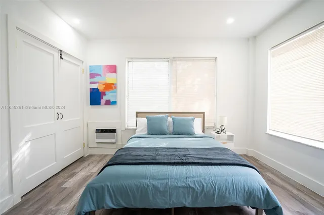 a kitchen with granite countertop cabinets stainless steel appliances a sink and a window