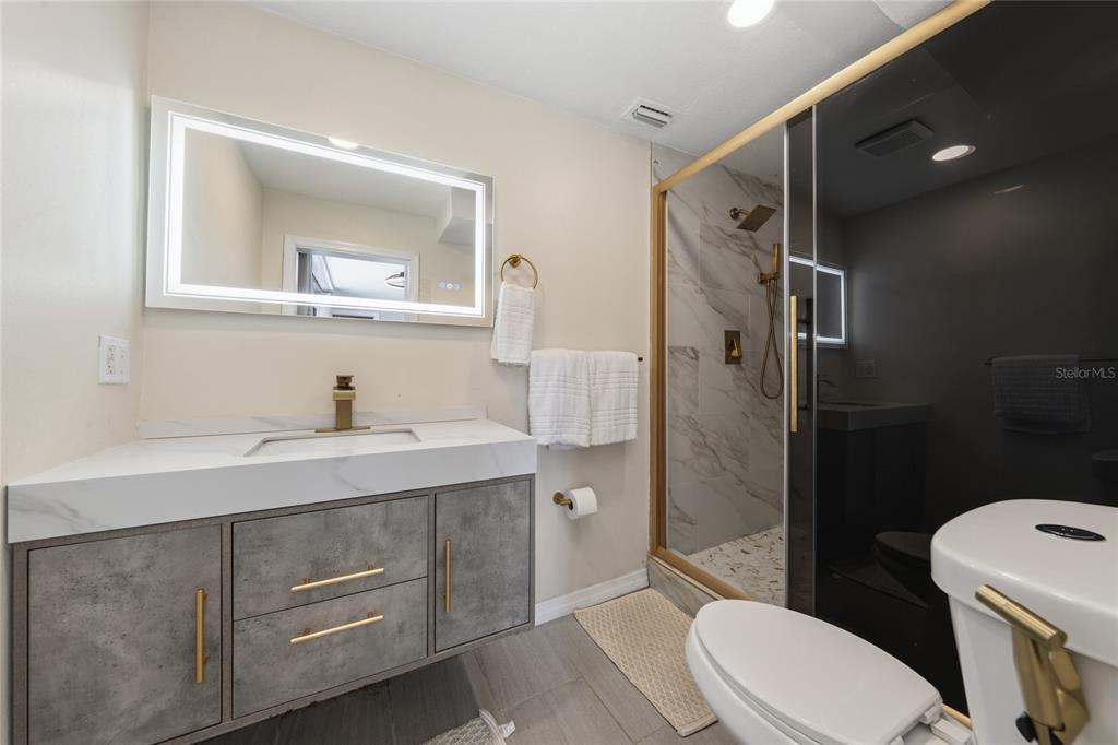 357 Ridgewood Street Altamonte Springs, FL 32701 - Photo 15 of 36 a bathroom with a sink toilet and shower