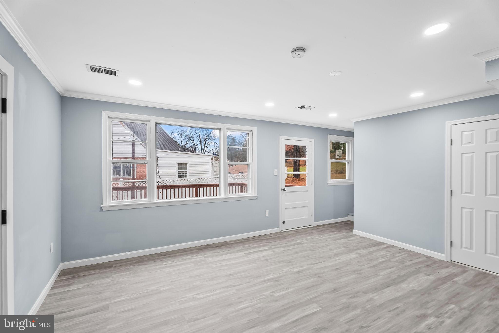 4302 Henderson Road Temple Hills, MD 20748 - Photo 14 of 33 a view of an empty room with a window and wooden floor