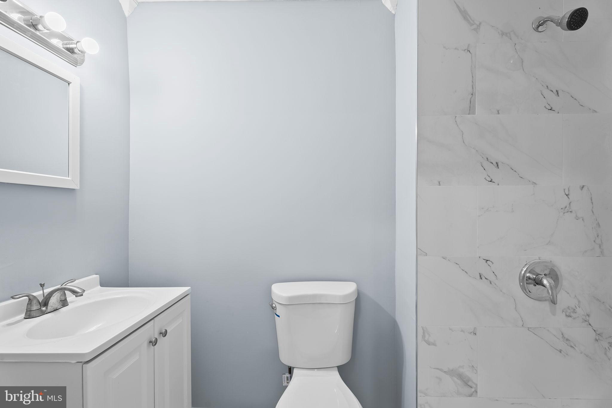 4302 Henderson Road Temple Hills, MD 20748 - Photo 15 of 33 a bathroom with a sink a toilet and a mirror