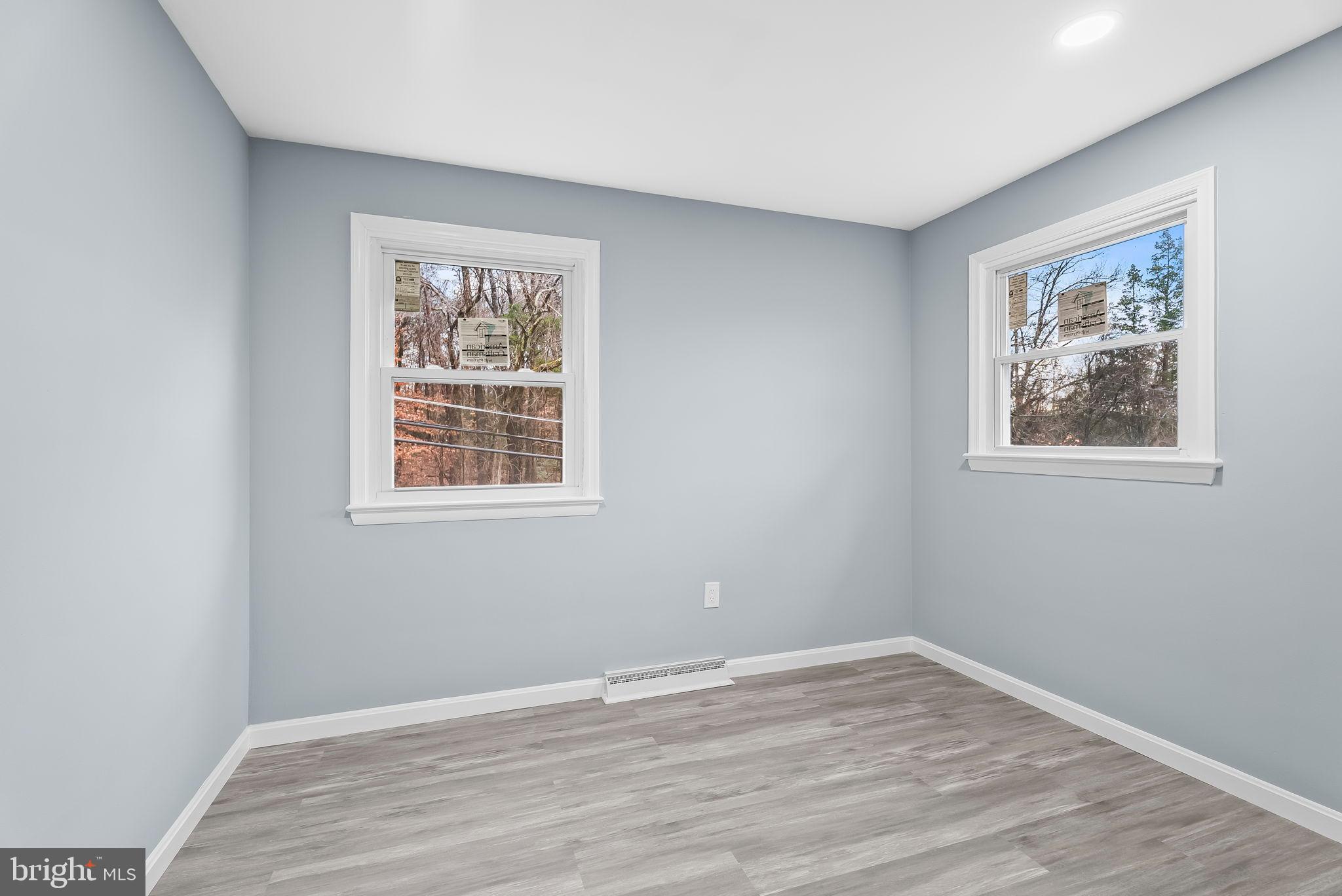 4302 Henderson Road Temple Hills, MD 20748 - Photo 23 of 33 a view of an empty room with wooden floor and a window