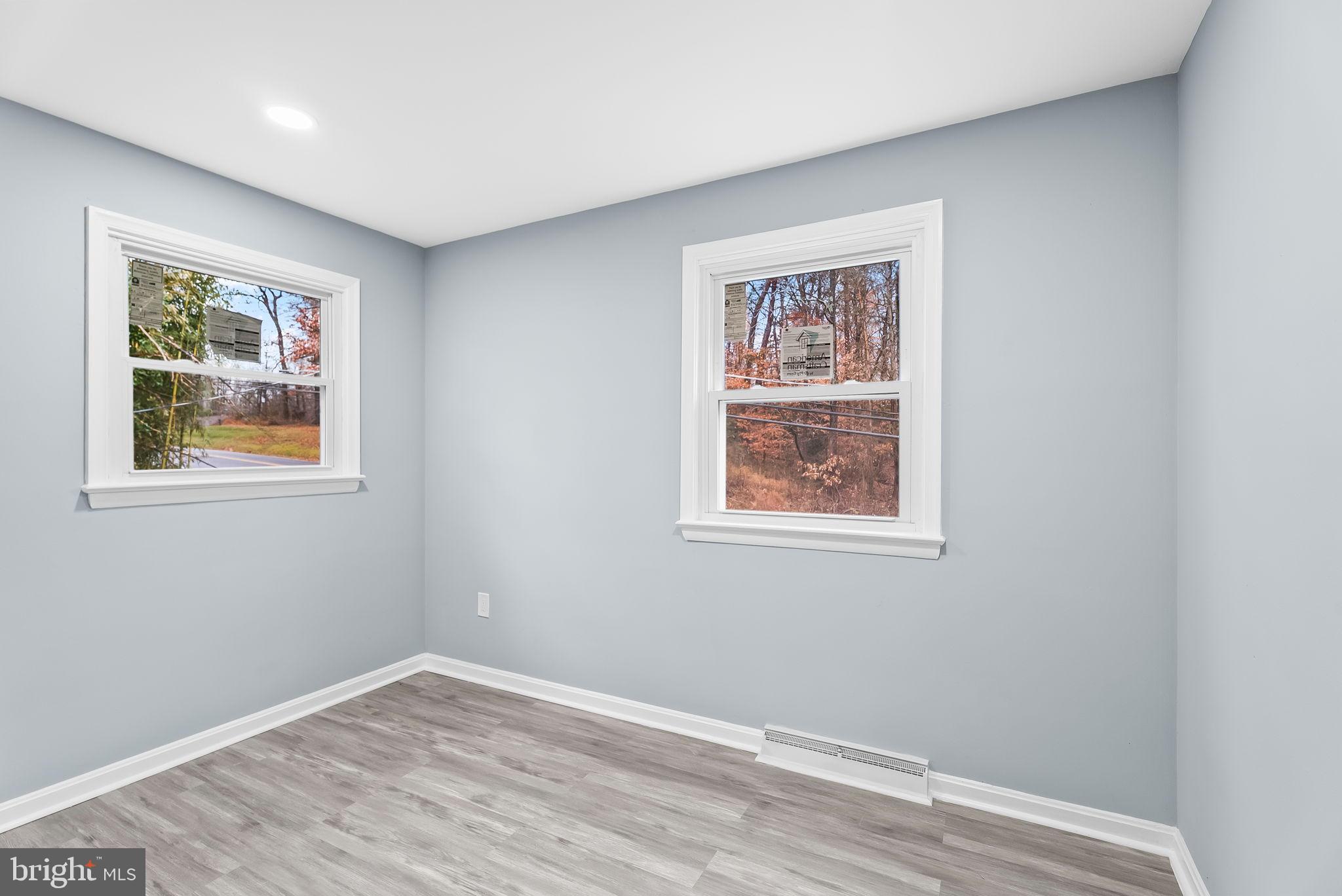 4302 Henderson Road Temple Hills, MD 20748 - Photo 24 of 33 a view of an empty room with window and wooden floor