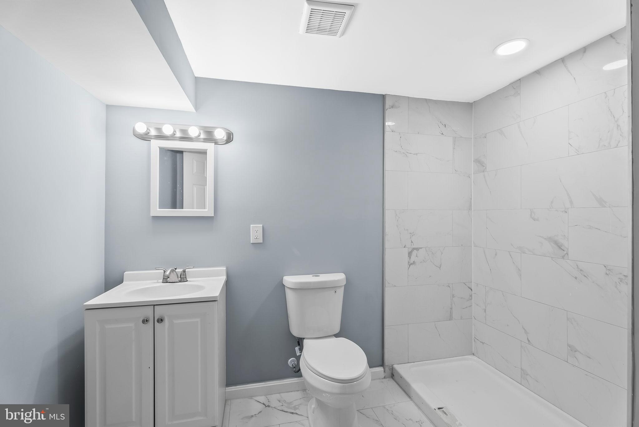 4302 Henderson Road Temple Hills, MD 20748 - Photo 28 of 33 a bathroom with a toilet a sink and shower