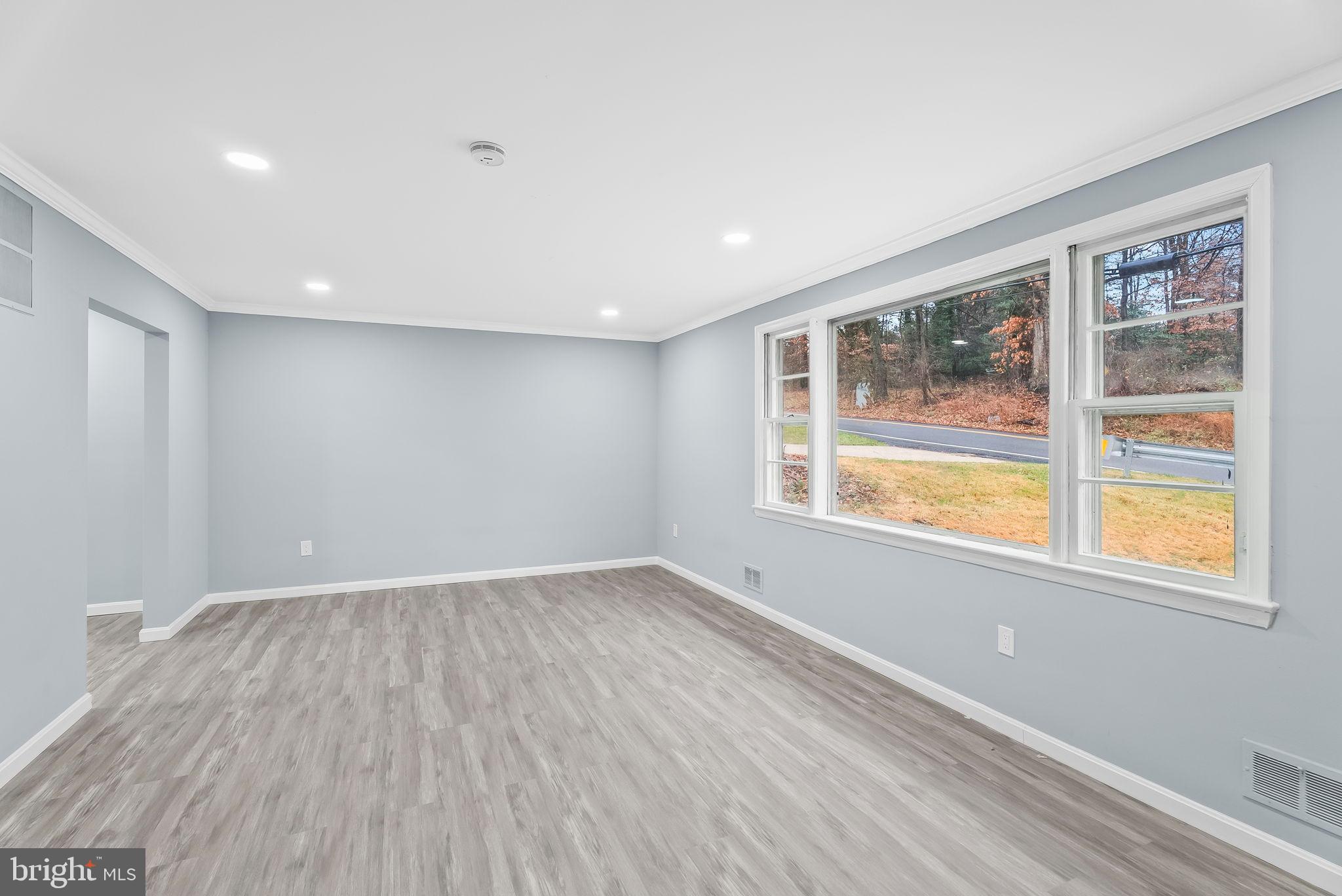 4302 Henderson Road Temple Hills, MD 20748 - Photo 5 of 33 a view of an empty room with wooden floor and a window