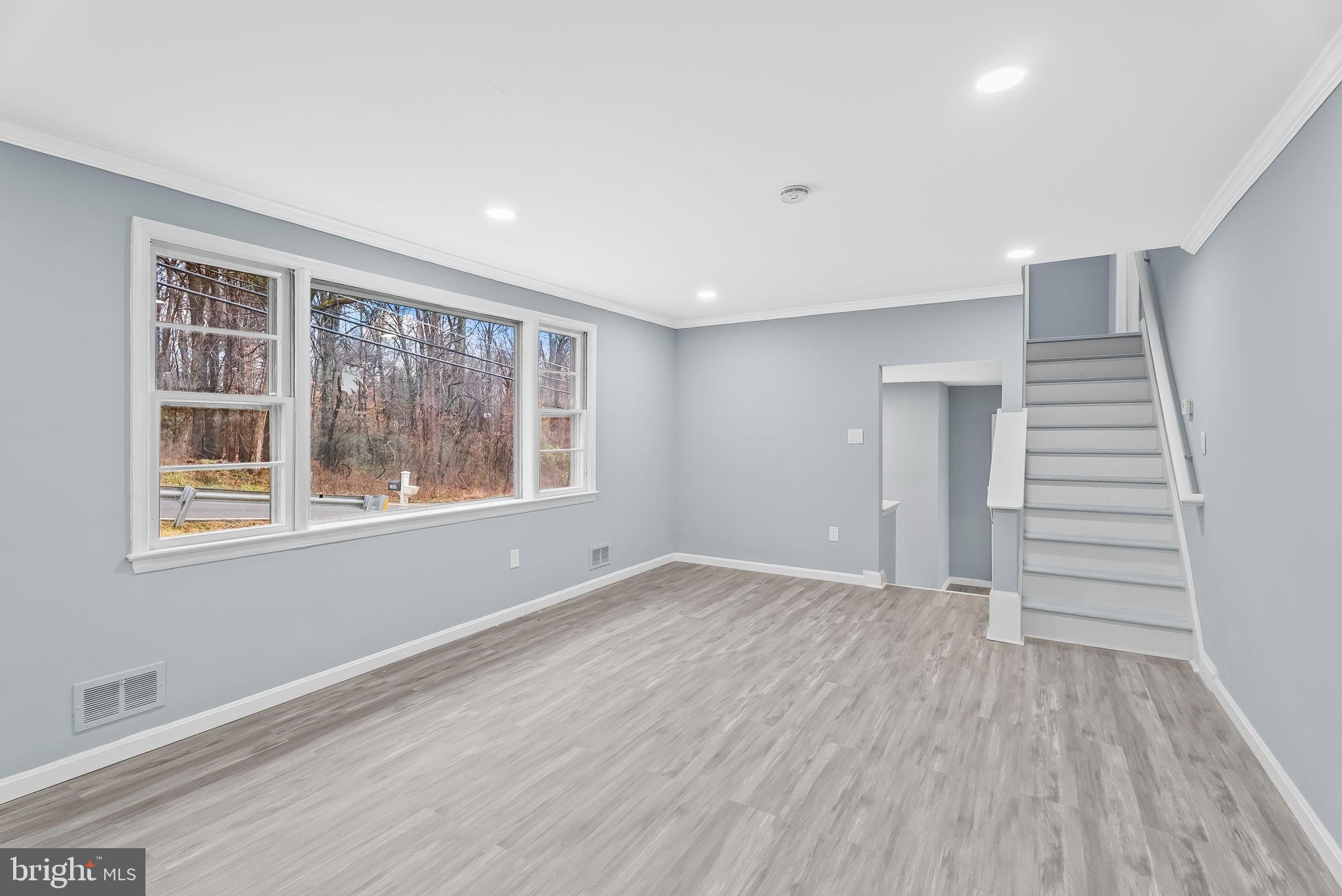 4302 Henderson Road Temple Hills, MD 20748 - Photo 6 of 33 a view of an empty room with wooden floor and a window
