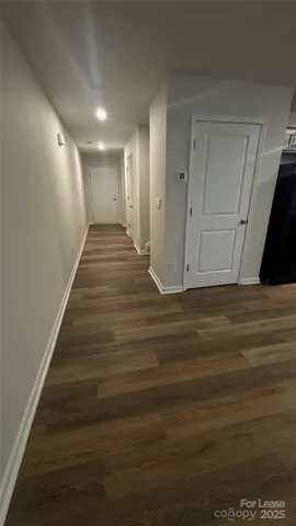 a view of gallery with wooden floor