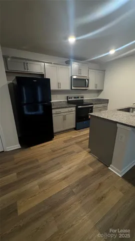 a kitchen with a stove and a refrigerator