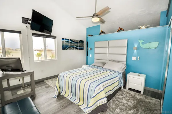 a bedroom with a bed and flat screen tv