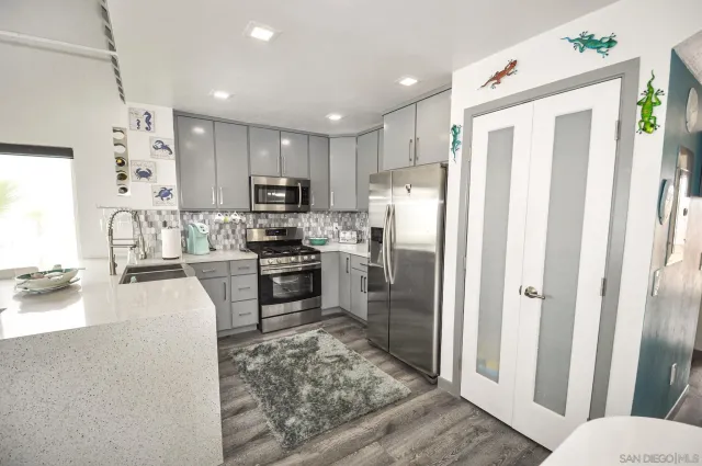 a kitchen with stainless steel appliances granite countertop a refrigerator stove and oven