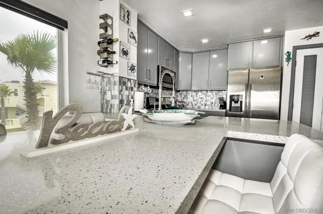 a kitchen with a sink cabinets and a large window