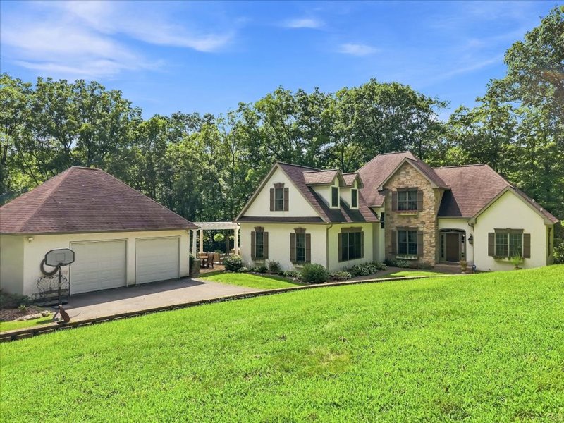 1168 Mt Pleasant Road Bangor, PA 18013 - Photo 23 of 100 An inviting stone and stucco exterior sits nestled against a lush backdrop of mature trees.