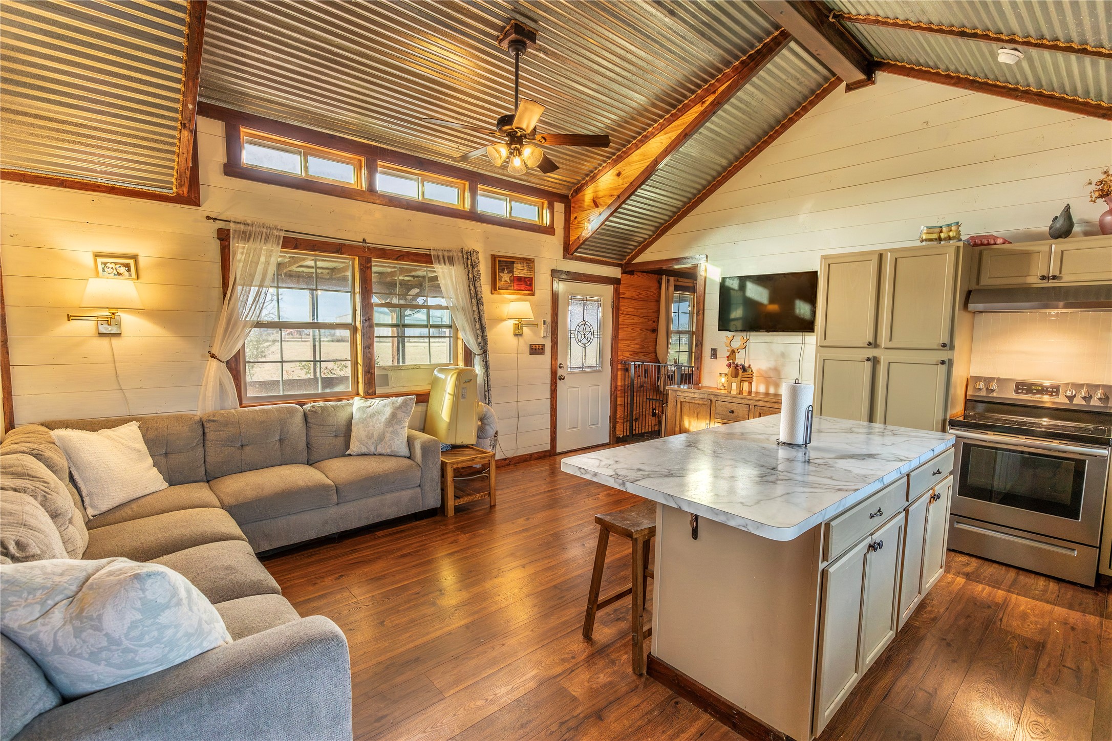 2726 Remmert Road Bellville, TX 77418 - Photo 2 of 18 a living room with stainless steel appliances kitchen island granite countertop furniture and a wooden floor