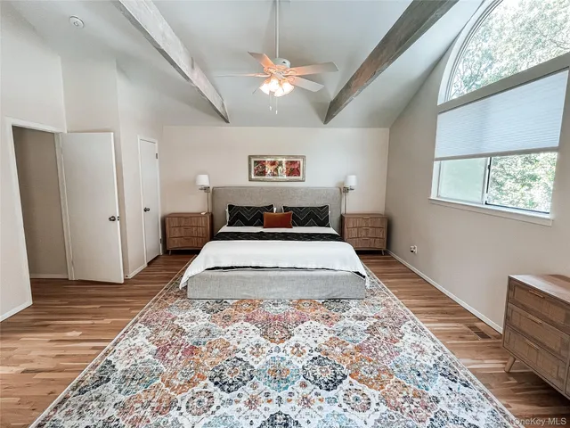 a bedroom with a large bed and a chandelier