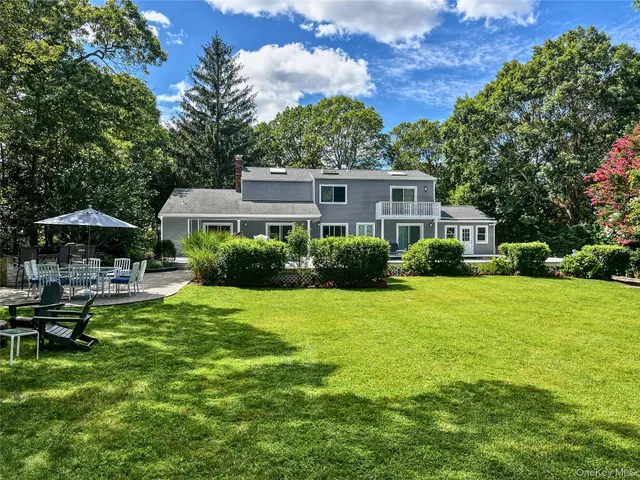 a house view with swimming pool and garden space