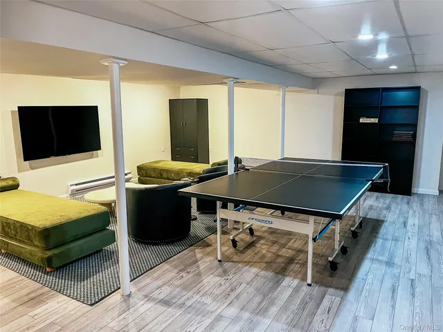 a living room with a table chairs and a flat screen tv