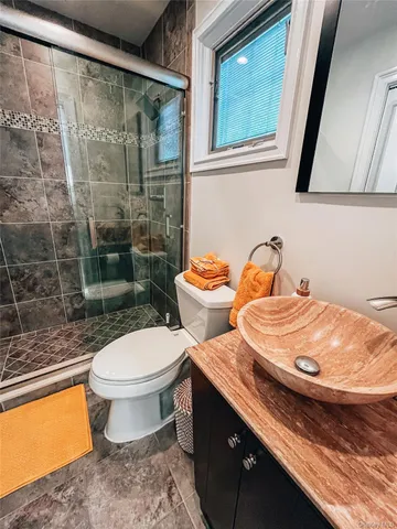 a bathroom with a toilet sink and mirror