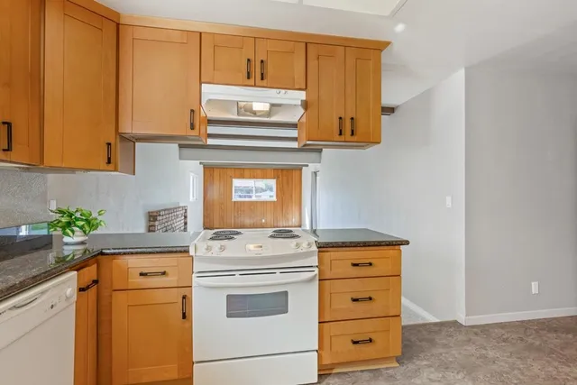 a kitchen with appliances cabinets and a counter top space