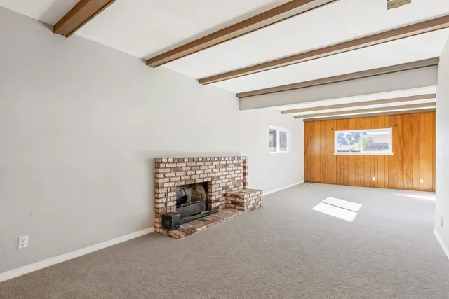 a view of an empty room and a window