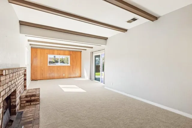 a view of an empty room and a window