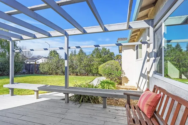 a view of a porch with chairs and backyard