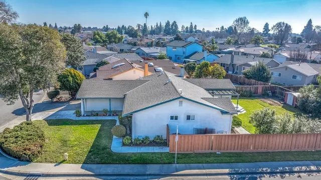 an aerial view of a house with garden space and outdoor seating