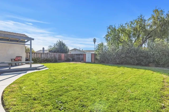 a swimming pool with outdoor seating and yard