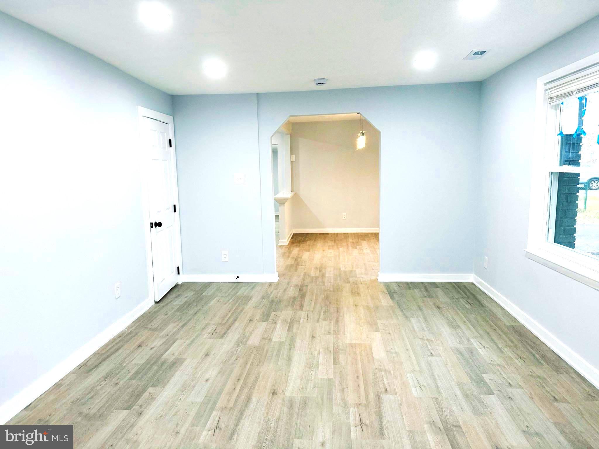 203 Henson Road Glen Burnie, MD 21060 - Photo 11 of 44 an empty room with wooden floor and windows