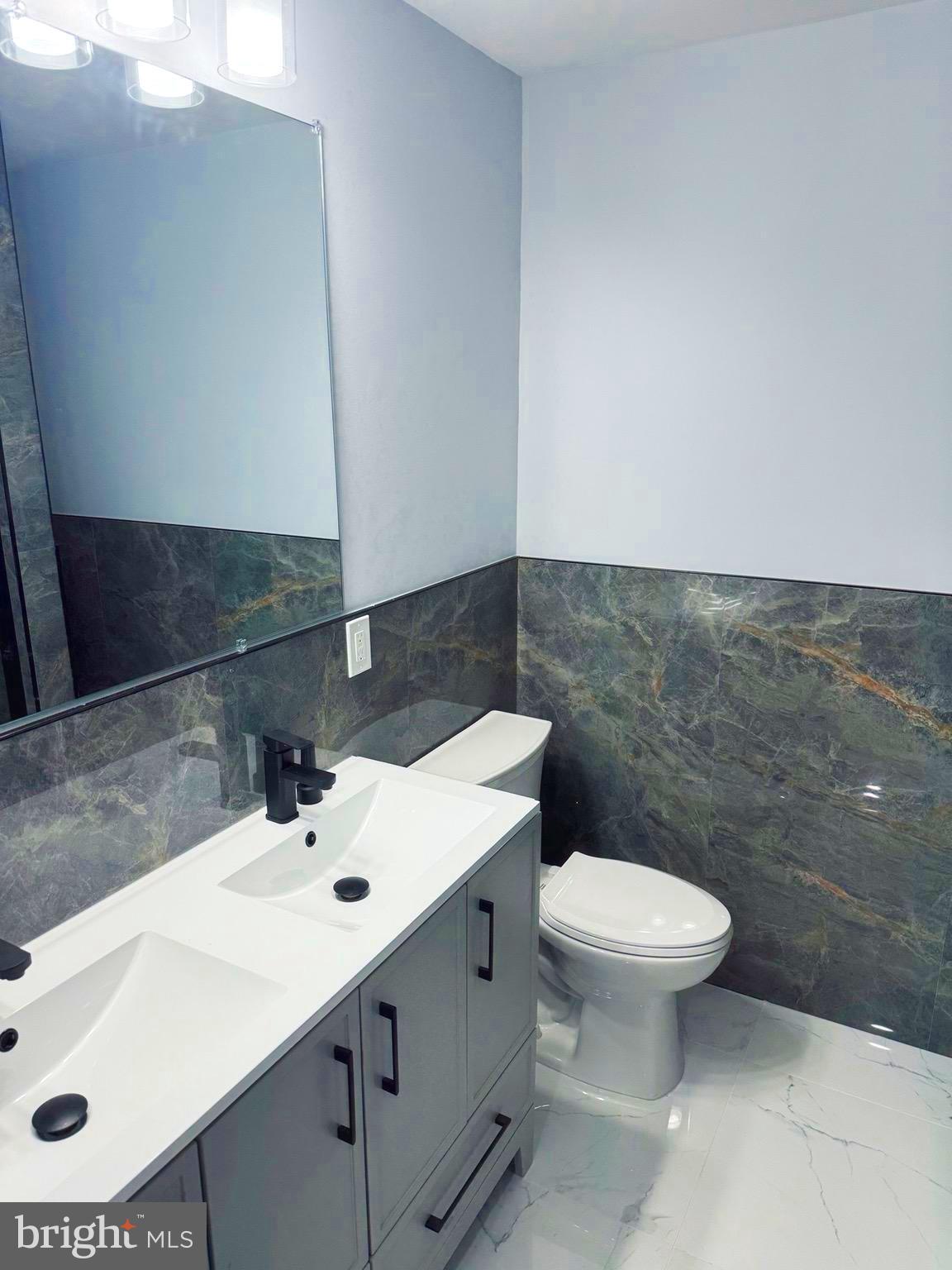 203 Henson Road Glen Burnie, MD 21060 - Photo 17 of 44 a bathroom with a sink toilet and mirror