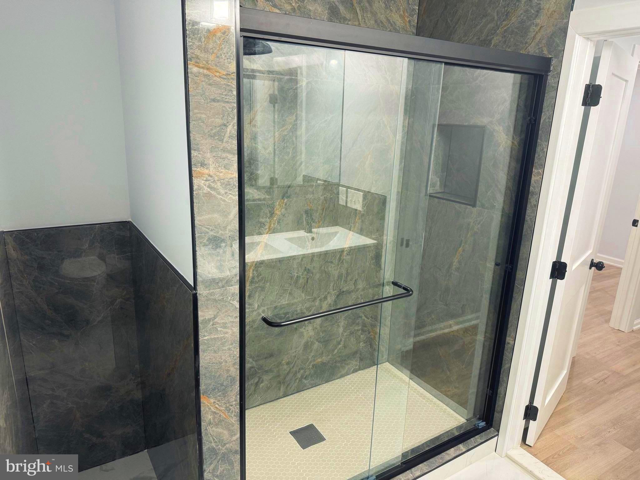 203 Henson Road Glen Burnie, MD 21060 - Photo 18 of 44 a bathroom with a glass shower door