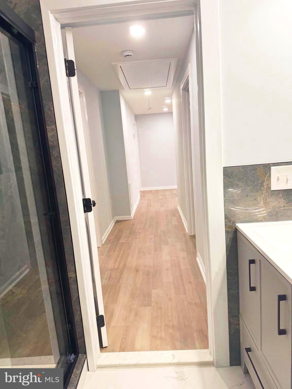 203 Henson Road Glen Burnie, MD 21060 - Photo 19 of 44 a view of a hallway with wooden floor and staircase