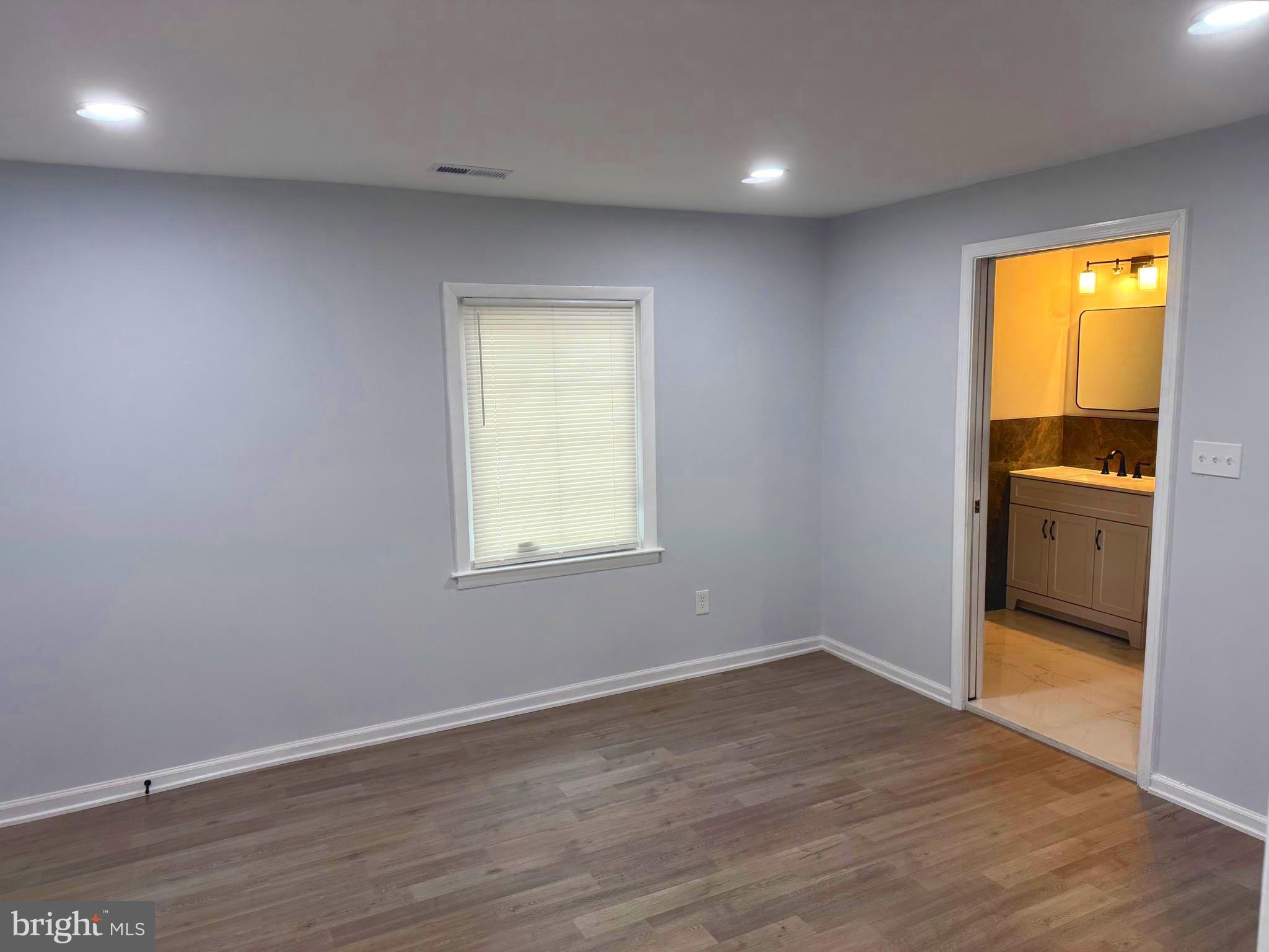 203 Henson Road Glen Burnie, MD 21060 - Photo 25 of 44 wooden floor in an empty room with a window