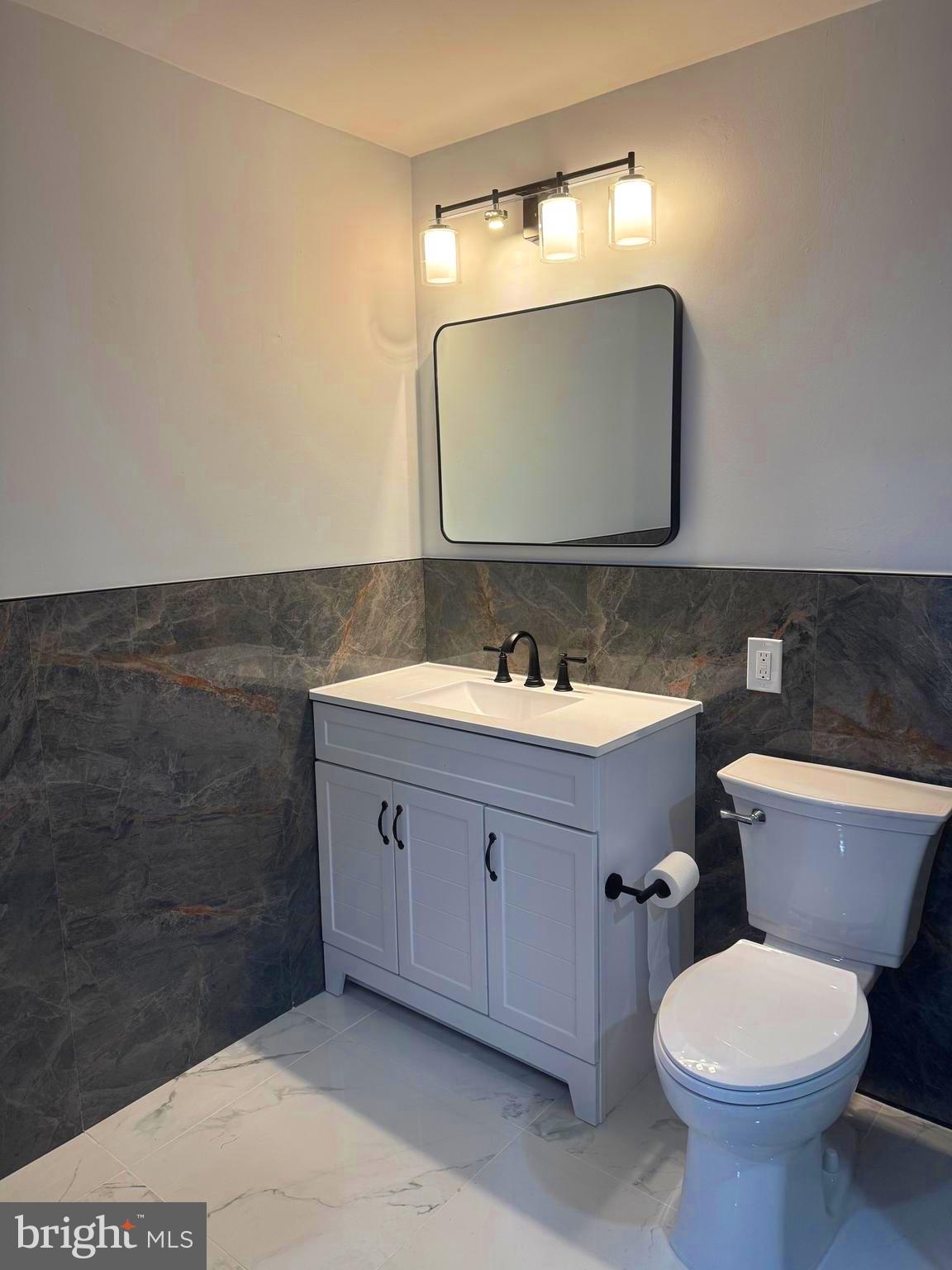 203 Henson Road Glen Burnie, MD 21060 - Photo 30 of 44 a bathroom with a toilet sink and mirror