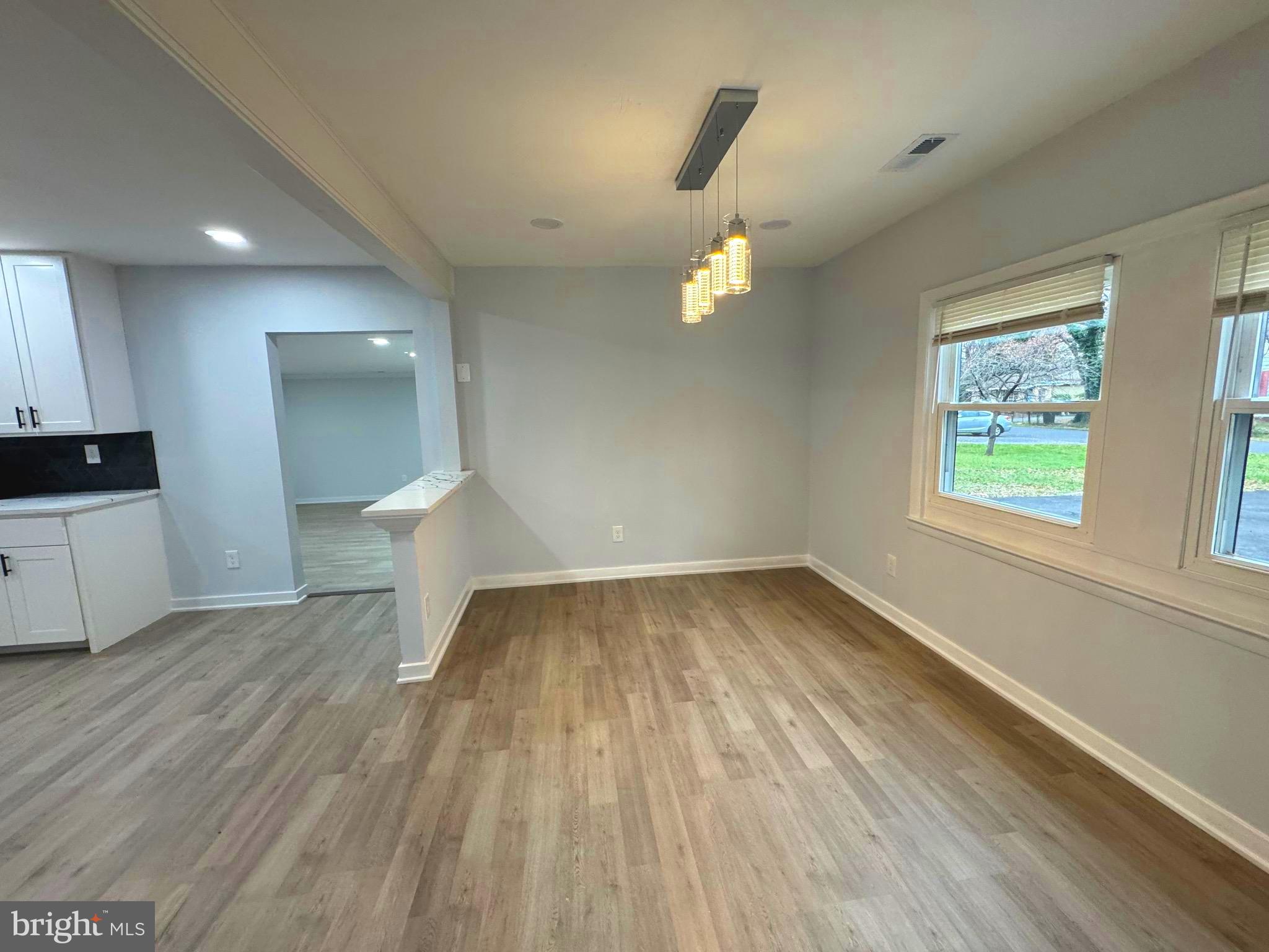 203 Henson Road Glen Burnie, MD 21060 - Photo 34 of 44 a view of empty room with wooden floor and fan